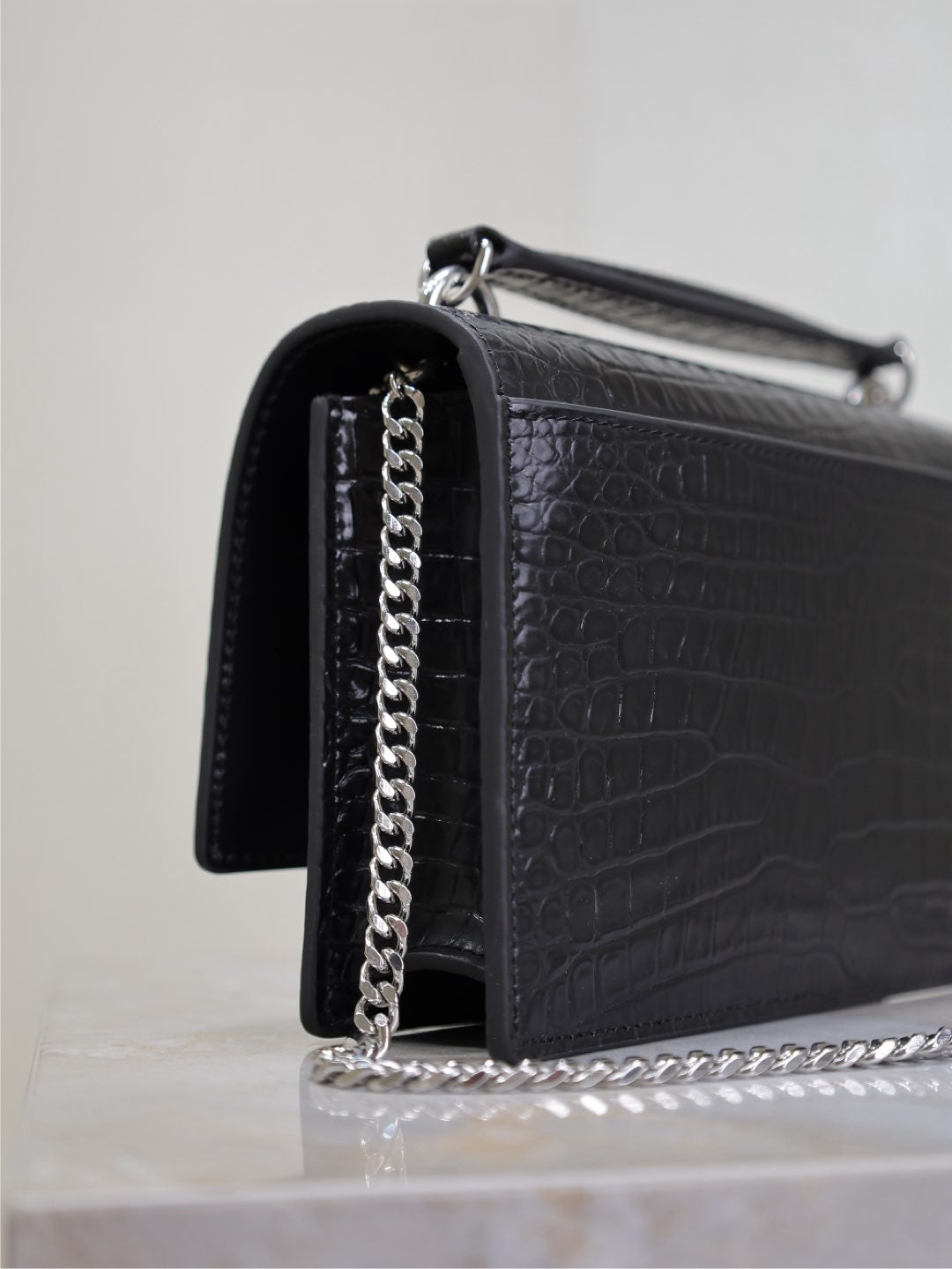 YSL croc-embossed shoulder bag with chain strap and metal top handle, black.