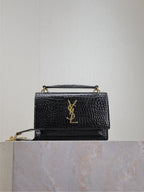 Black YSL leather shoulder bag with gold-tone chain and YSL logo at front flap.