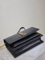 Black croc-textured flap bag with gold-tone YSL logo and chain strap.