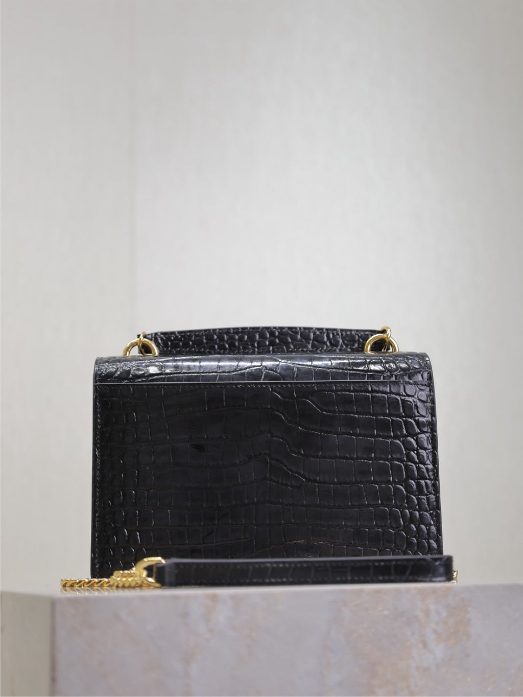 Black croc-textured shoulder bag with top handle and gold-tone hardware.