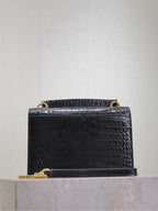 Black croc-textured shoulder bag with top handle and gold-tone hardware.