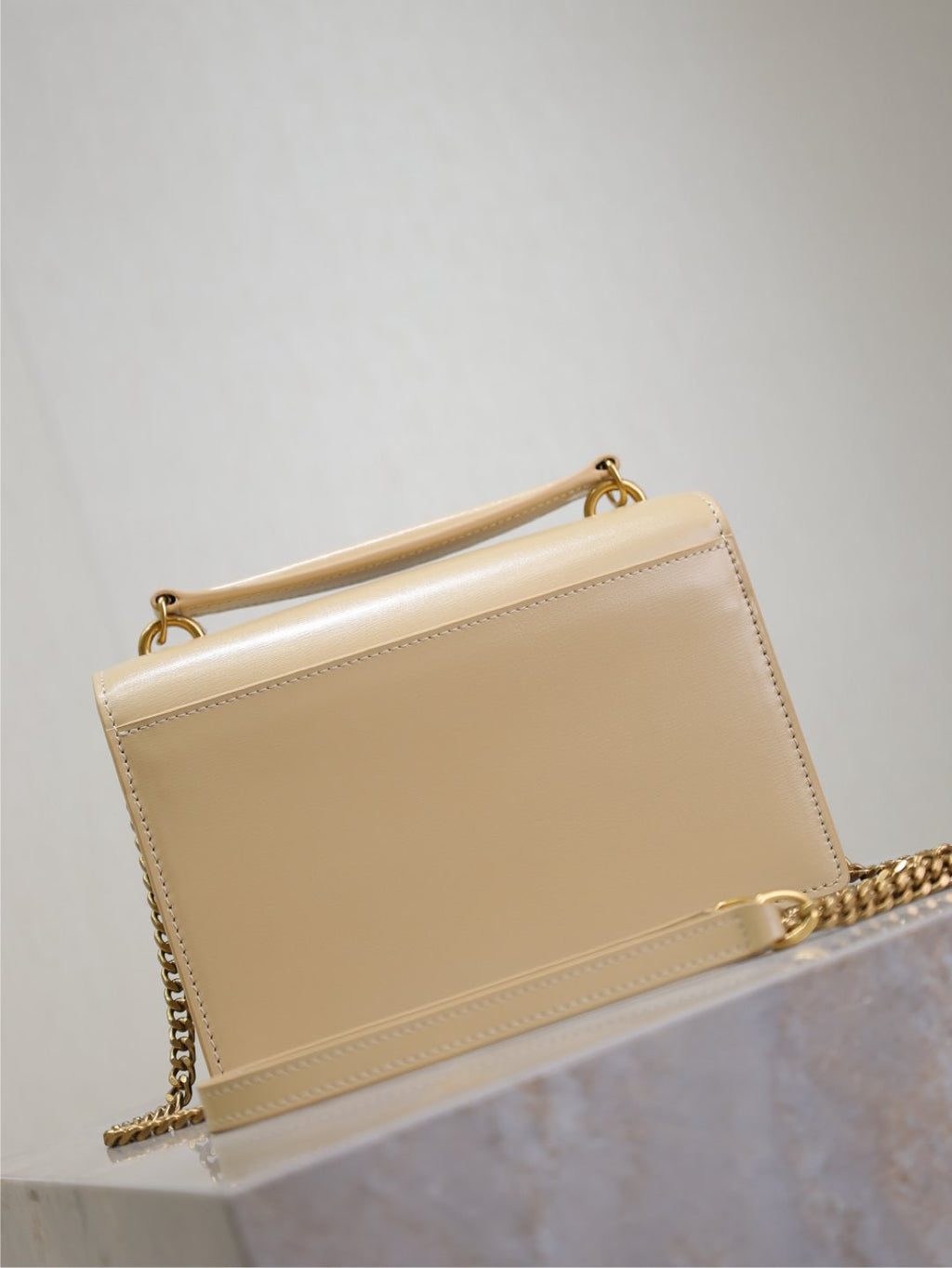 YSL small bag in cream with gold-tone chain strap and stitched flap edge
