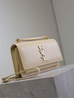 YSL shoulder bag in cream with gold-tone chain strap and YSL logo on front flap