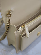 YSL cream bag interior corner with zipper pull, chain attachment, and gold hardware