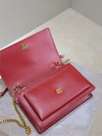 YSL red leather flap bag with open interior, gold snap buttons