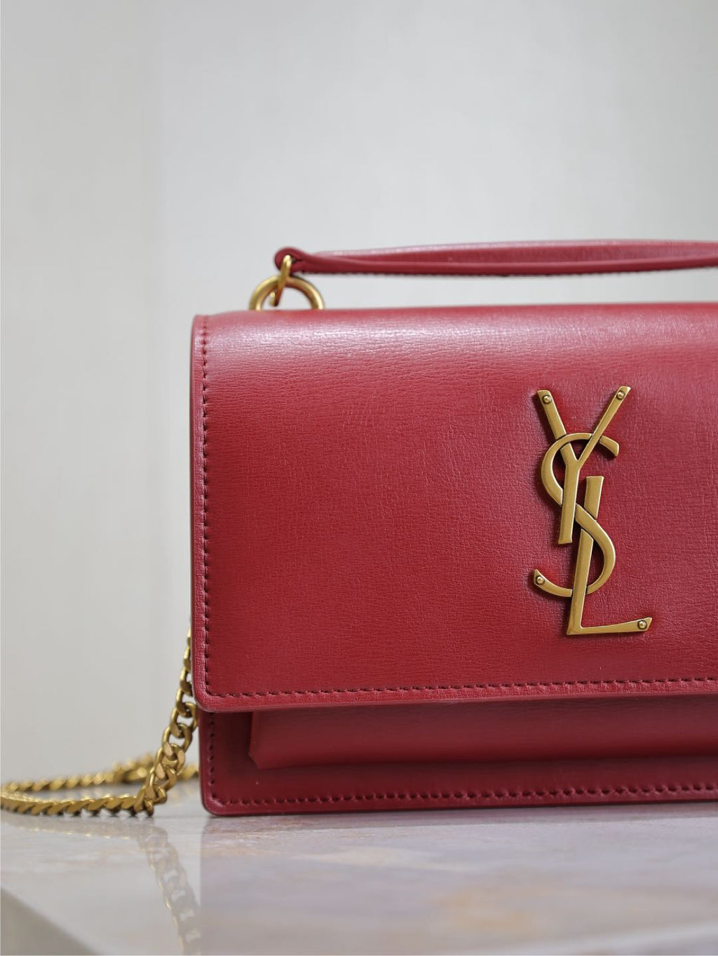 YSL red leather mini bag with gold YSL monogram on front flap