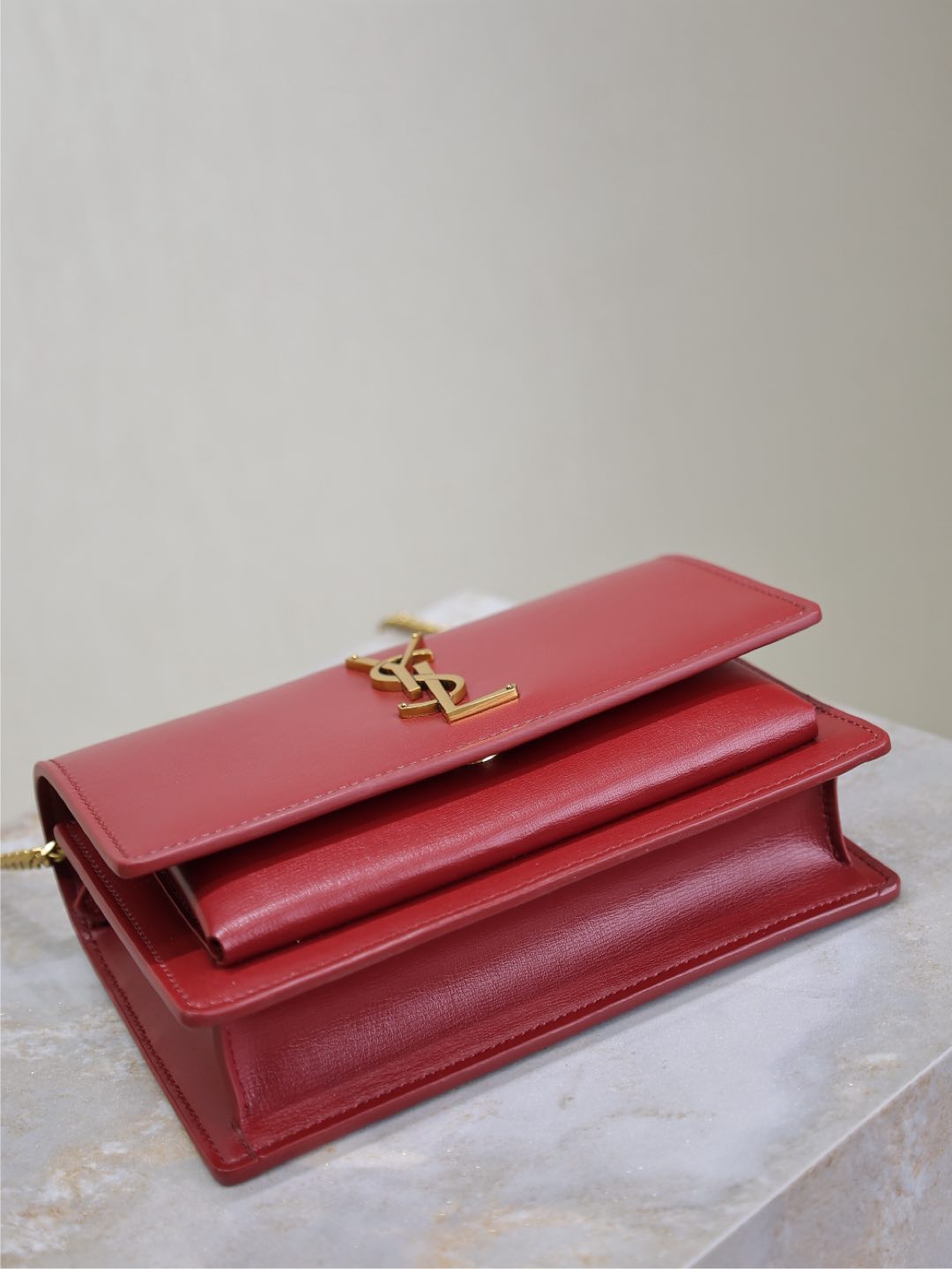 YSL red leather flap bag with gold YSL logo on front