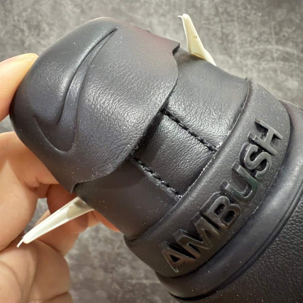 Black sneaker heel with embossed "AMBUSH" lettering