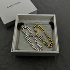Chain bracelet set in box: silver-tone and gold-tone link bracelets with tassel pull cords