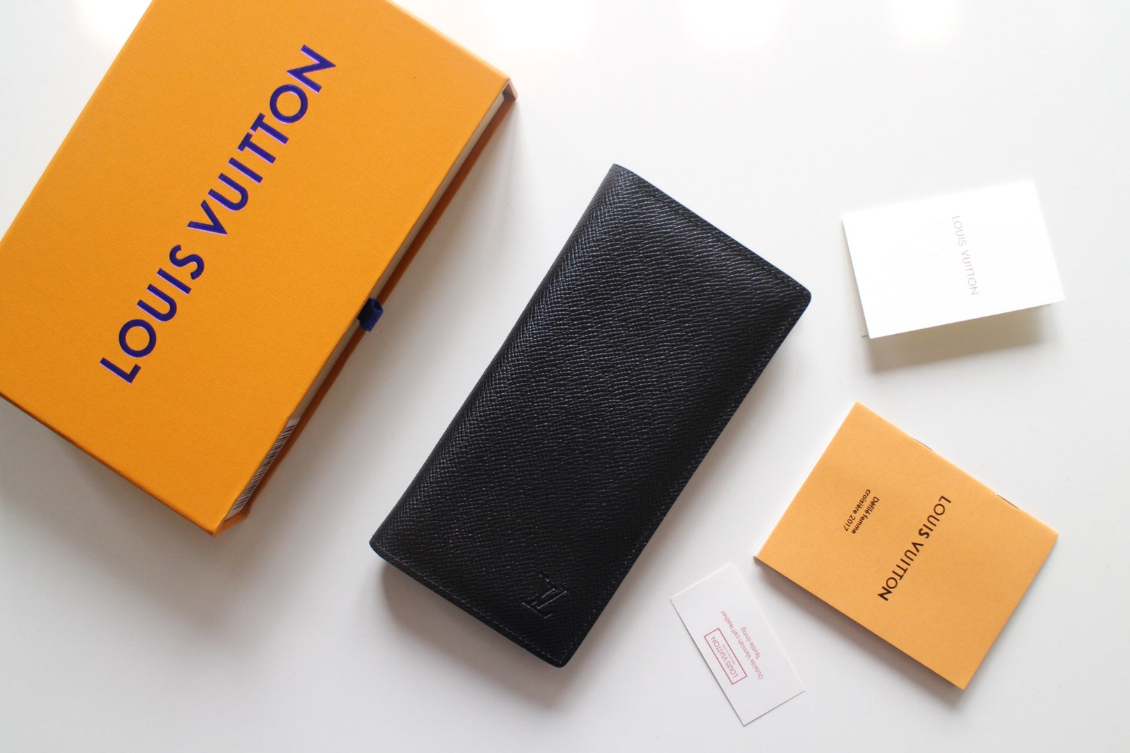 Small Louis Vuitton black textured cardholder, vertical with embossed LV logo