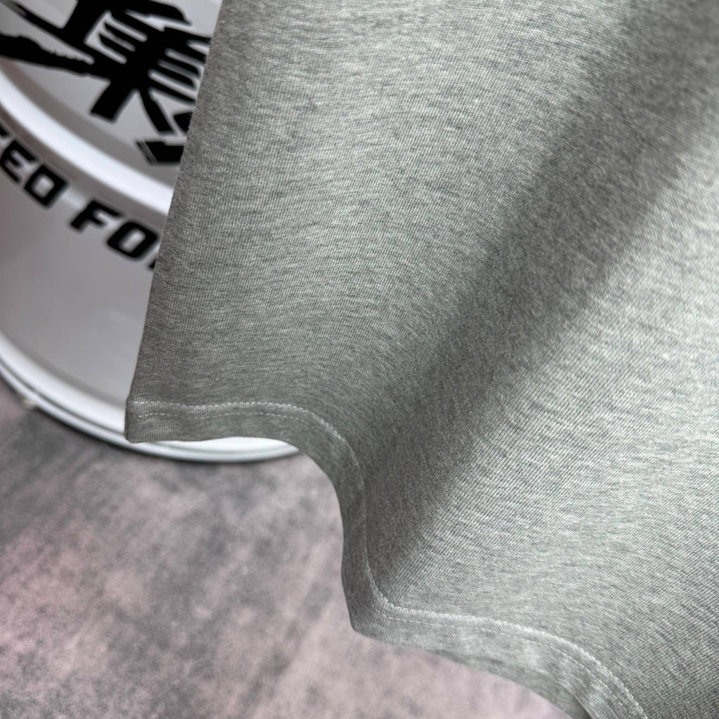 Heather gray T-shirt hem and sleeve cuff close-up.