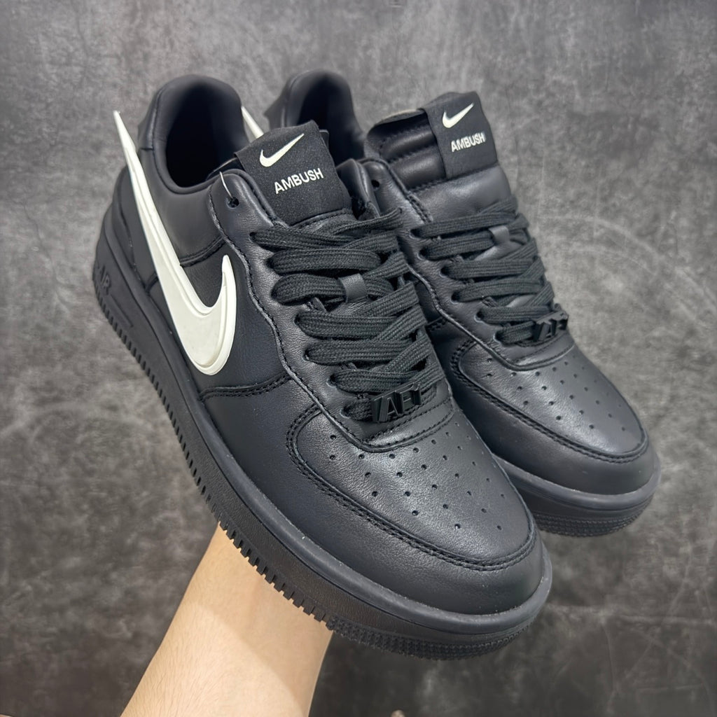 Black Nike Air Force 1 style sneakers with white Swoosh and lace-up uppers