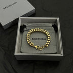 Balenciaga chain bracelet in gold tone with interlocking links and logo charm
