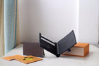 Louis Vuitton small black textured leather card pouch open to show inner slots