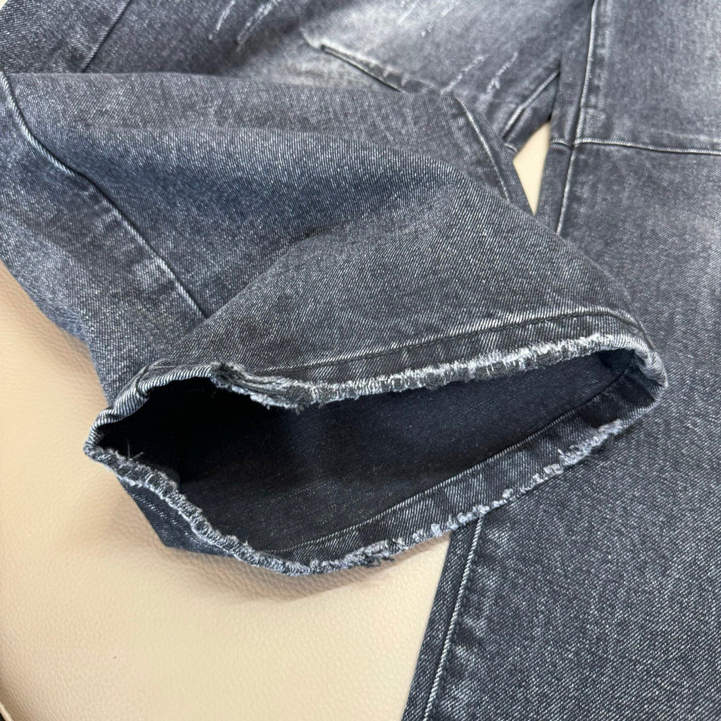 Dark wash denim jeans cuff with frayed hem opening