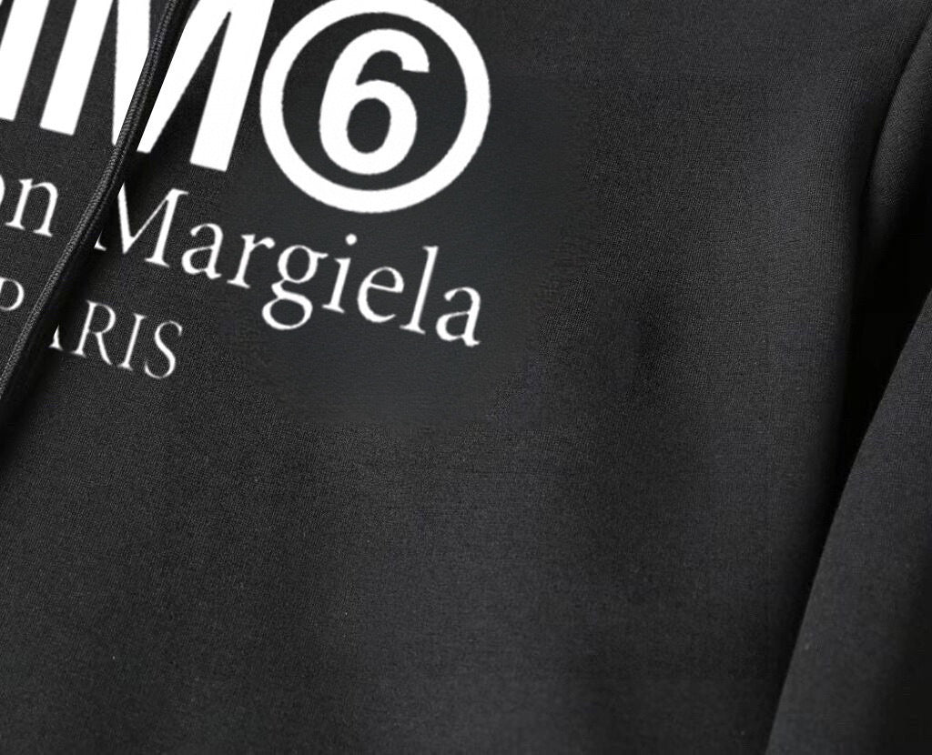 Black hoodie fabric close-up with MM6 Maison Margiela logo print