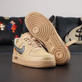 Cream Air Force 1 low-top sneakers with blue Nike swoosh and textured gum sole
