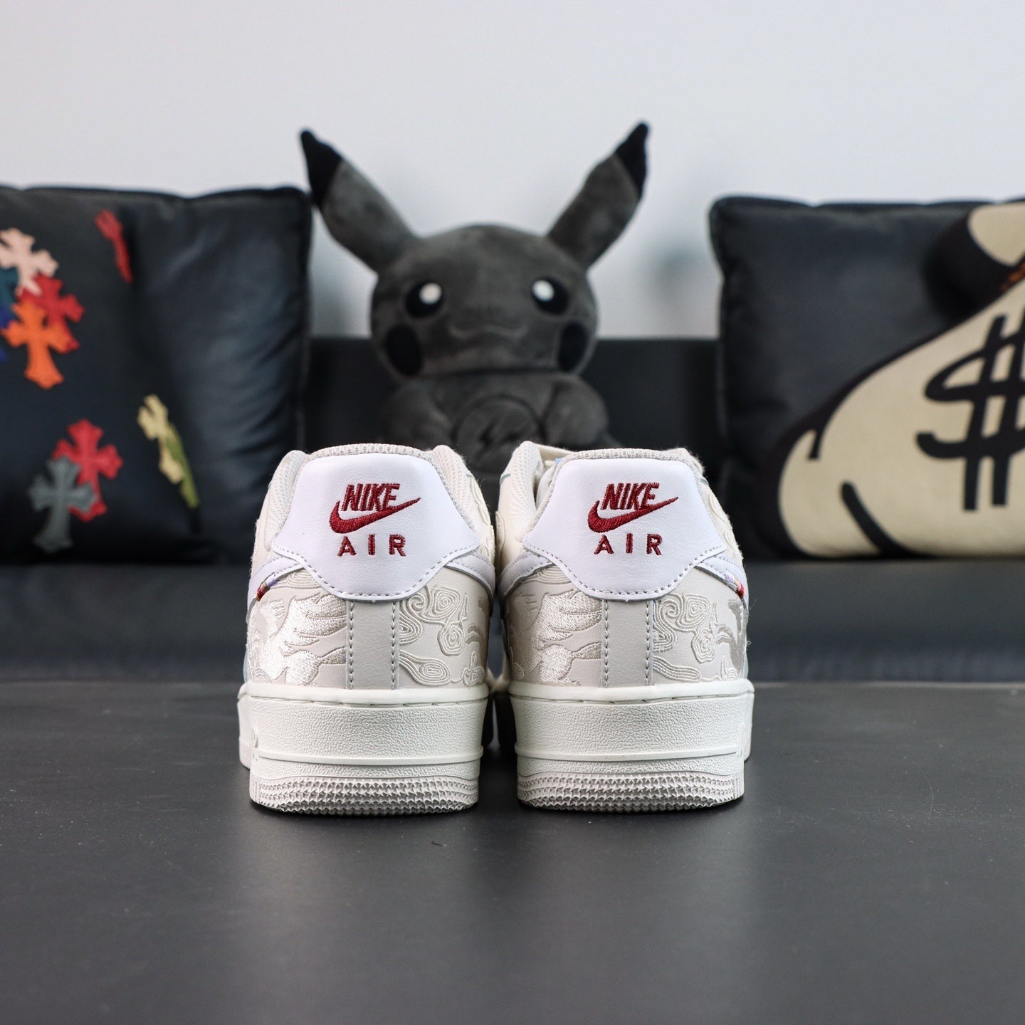 White Air Force 1 low sneakers with Nike Air heel tabs facing camera