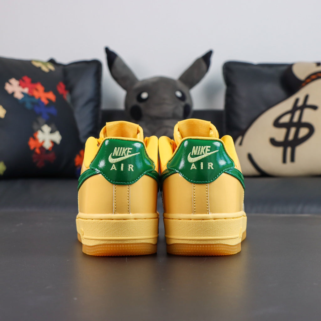 Nike Air Force 1 sneakers, yellow with green heel tabs and yellow gum sole