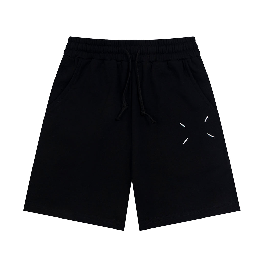 Black Maison Margiela shorts with elastic waist, drawstring, and dash line graphic.