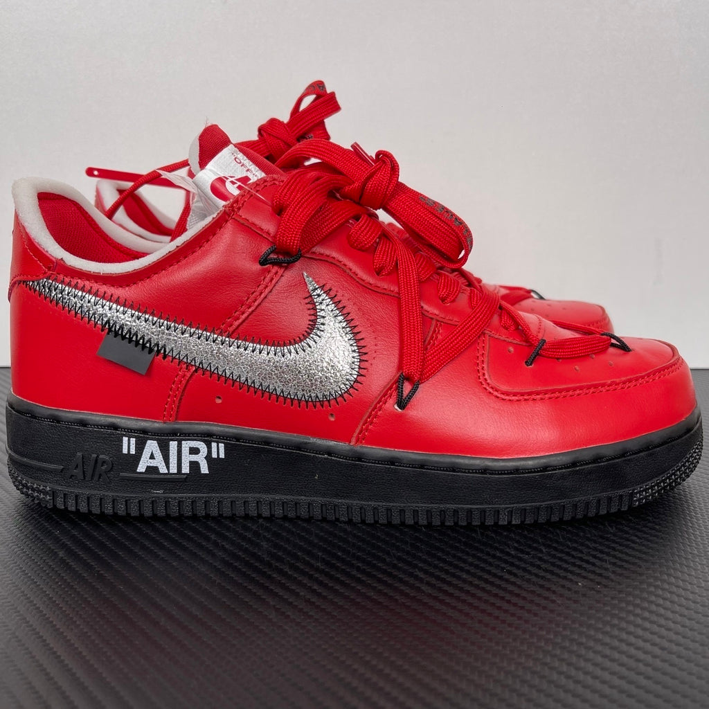 Red low-top sneakers with silver Nike swoosh, black midsole, red laces
