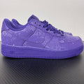Purple low-top sneakers with lace-up closure and embossed textured upper