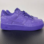 Purple low-top sneakers with lace-up closure and embossed textured upper