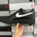 Black leather low-top sneaker with white swoosh and lace-up front