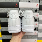 White low-top sneakers with Air-branded heel tabs, rear view