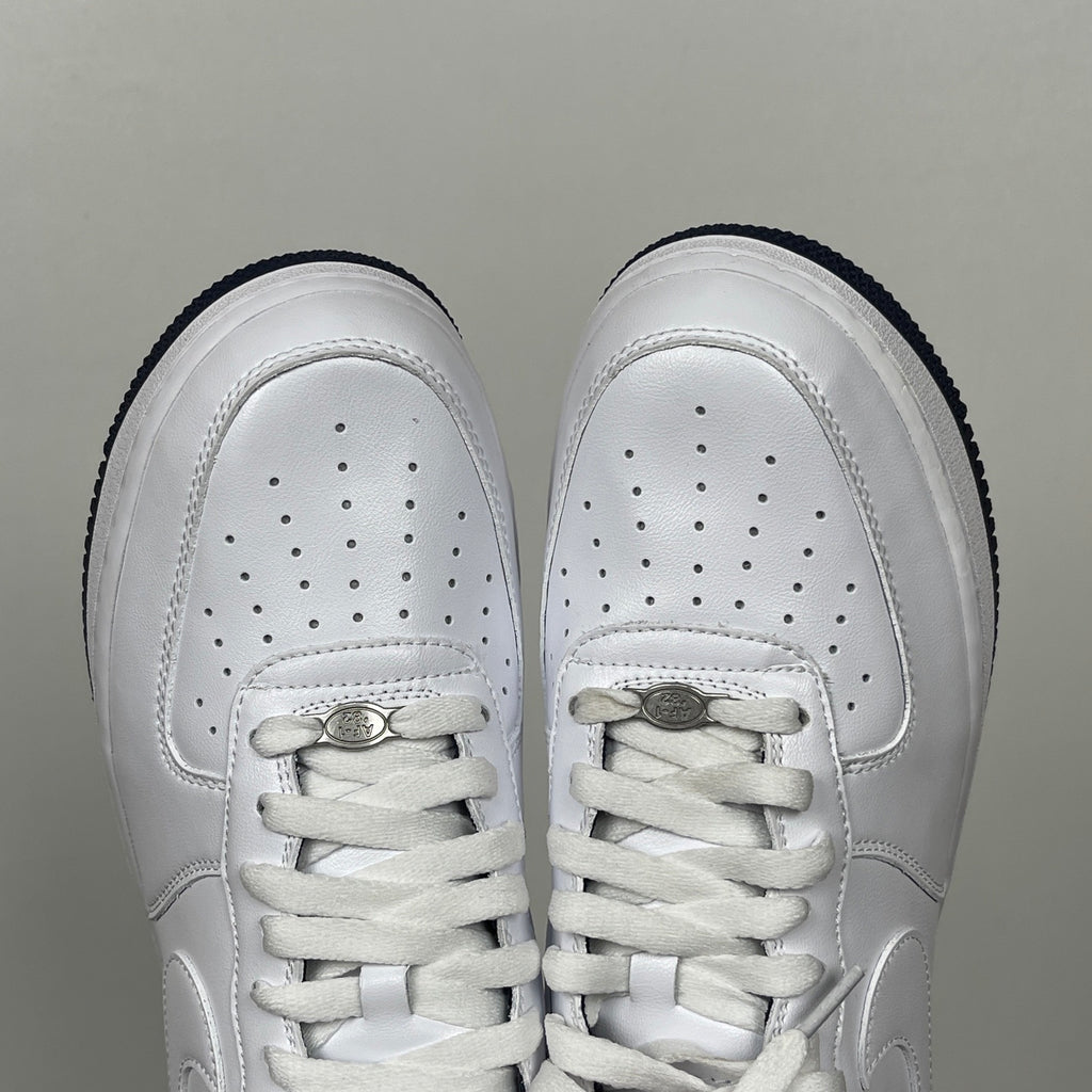 White Nike Air Force 1 toe view with perforations and lace-up closure