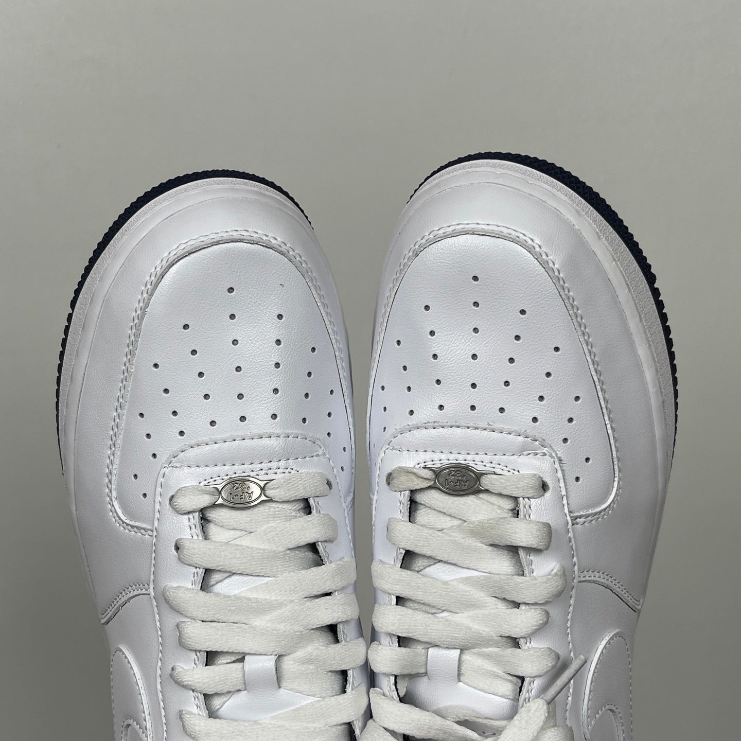 White Nike Air Force 1 toe view with perforations and lace-up closure
