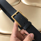 Textured dark leather belt with gold-tone buckle and engraved Prada label