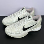 Pair of low-top sneakers angled view, white star upper, black swoosh, white laces
