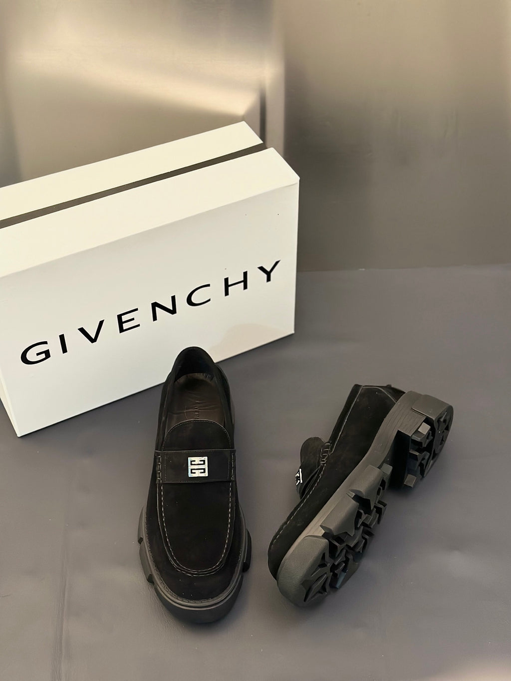 Black loafers slip-on style with square logo detail and chunky sole, top view