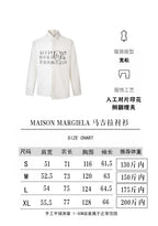 White button-up shirt with black number print across the chest