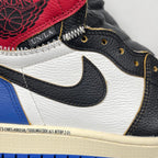 High-top sneaker upper close-up: red ankle patch, black swoosh, white leather, gold eyelets