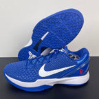 Blue Nike basketball sneaker with outsole tread, red lace detail, and white swoosh