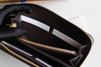 Louis Vuitton small bag interior with card slots and gold zipper track.