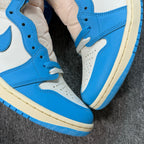Air Jordan 1 Retro High OG sneakers, close-up of lace area and blue leather panels