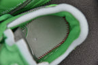 Green sneaker interior lining with white trim and visible stitching detail