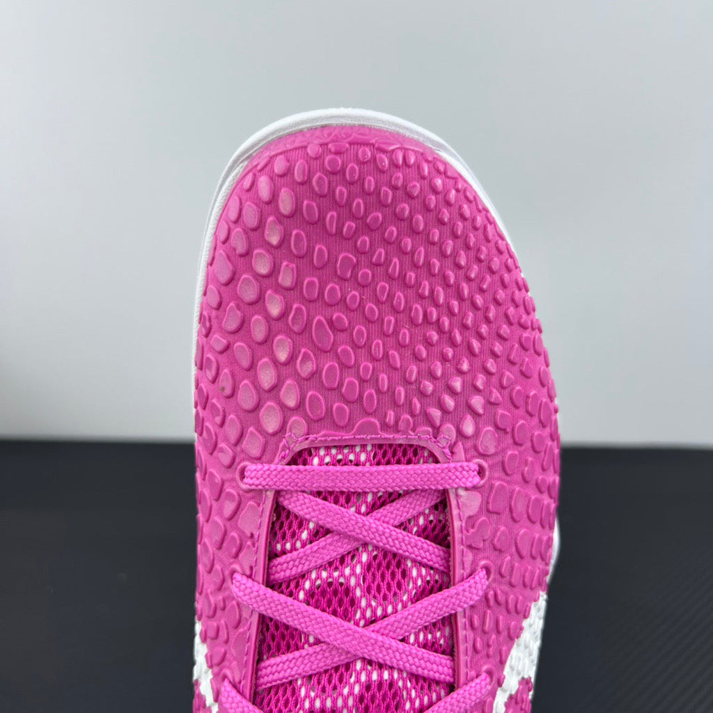 Pink sneaker outsole with lace-up opening detail and textured rubber tread