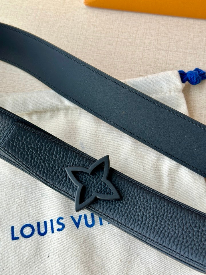 Close-up of navy leather belt with star-shaped engraved buckle and edge stitching
