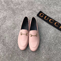 Pink Gucci loafers with gold-tone bit hardware, rounded toe, slip-on style