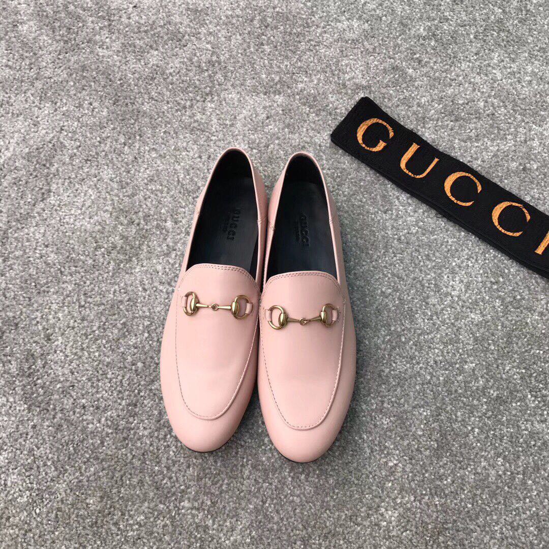 Pink Gucci loafers with gold-tone bit hardware, rounded toe, slip-on style