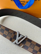 Louis Vuitton belt buckle close-up with silver V hardware on Damier check strap