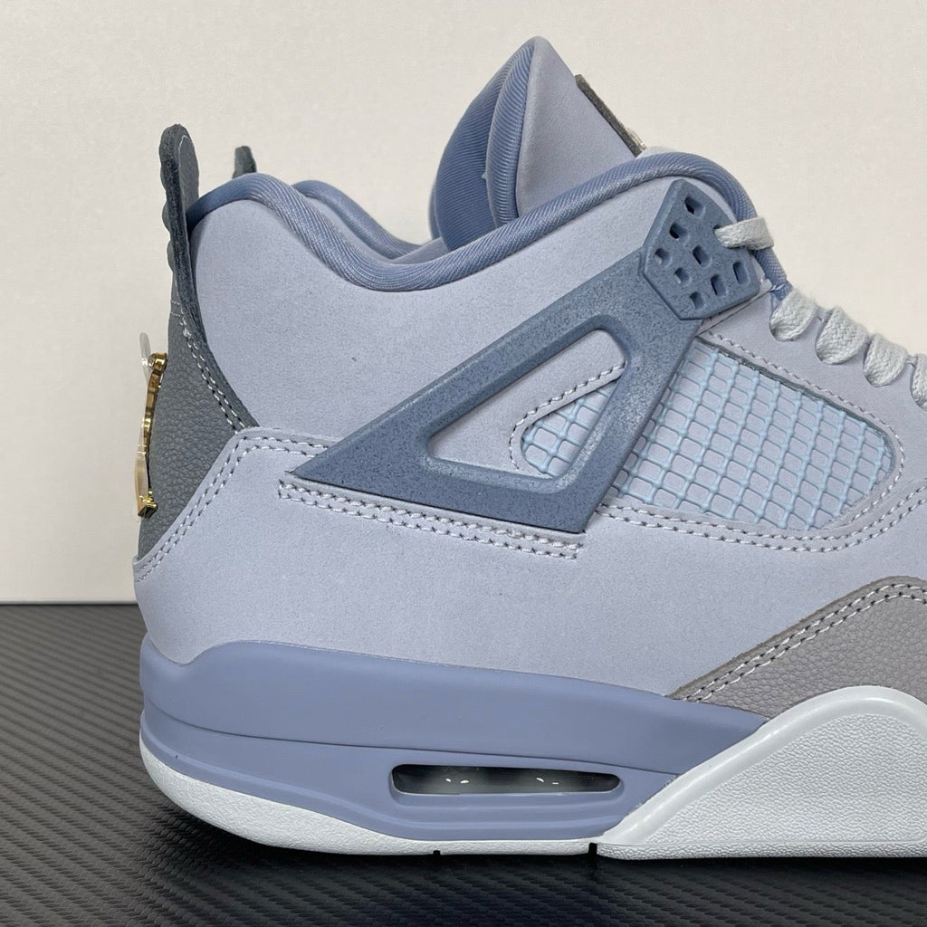 Light blue Air Jordan 4 sneaker with lace-up front, gray overlays, and visible air unit