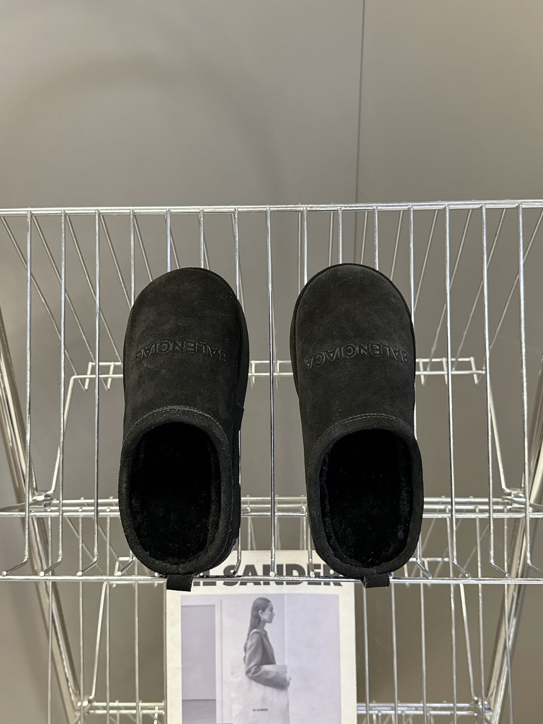 Balenciaga black suede slip-on sandals, underside view of two shoes