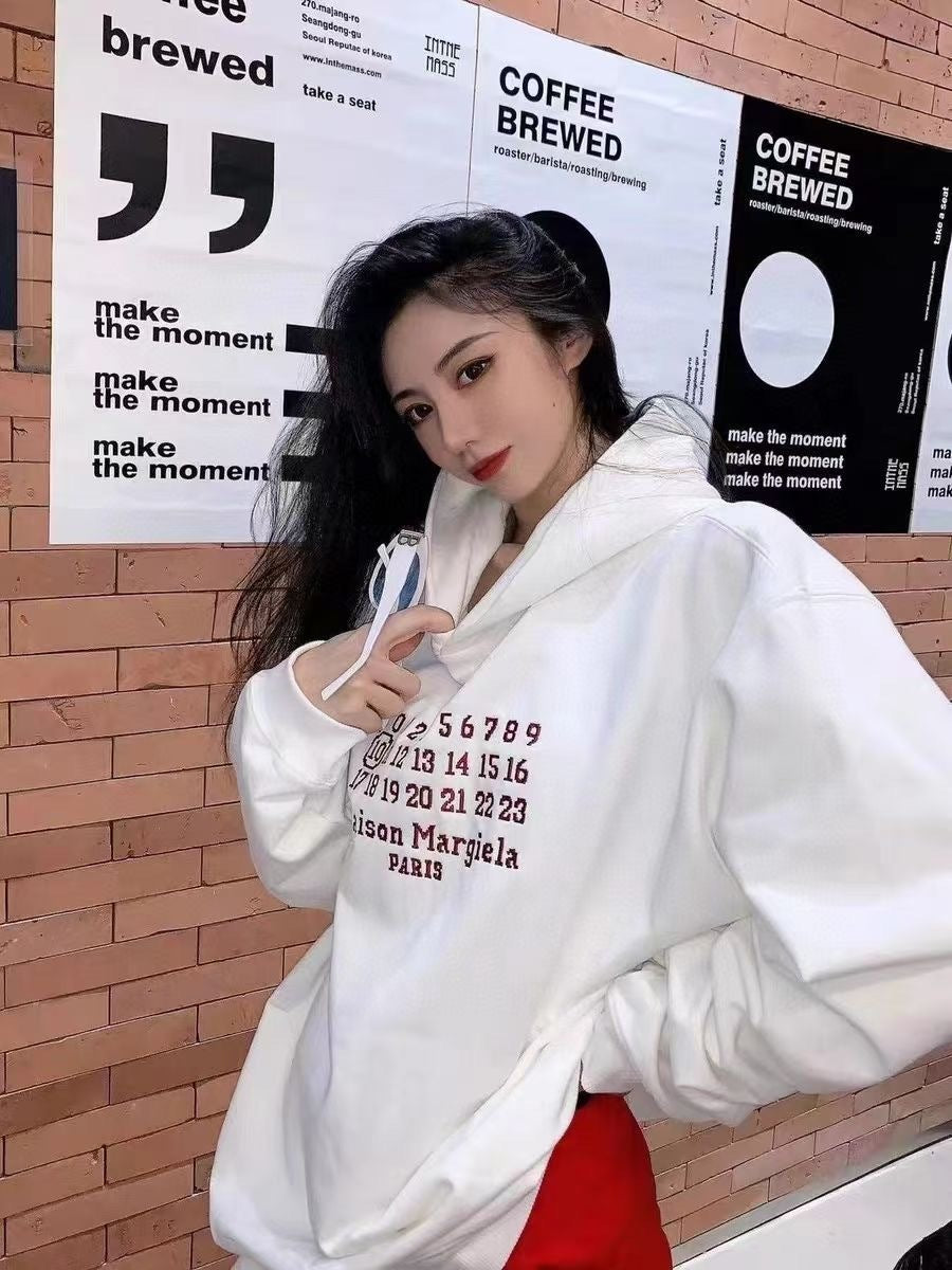 White Maison Margiela hoodie on model with red Paris graphic and hood