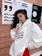 White Maison Margiela hoodie on model with red Paris graphic and hood