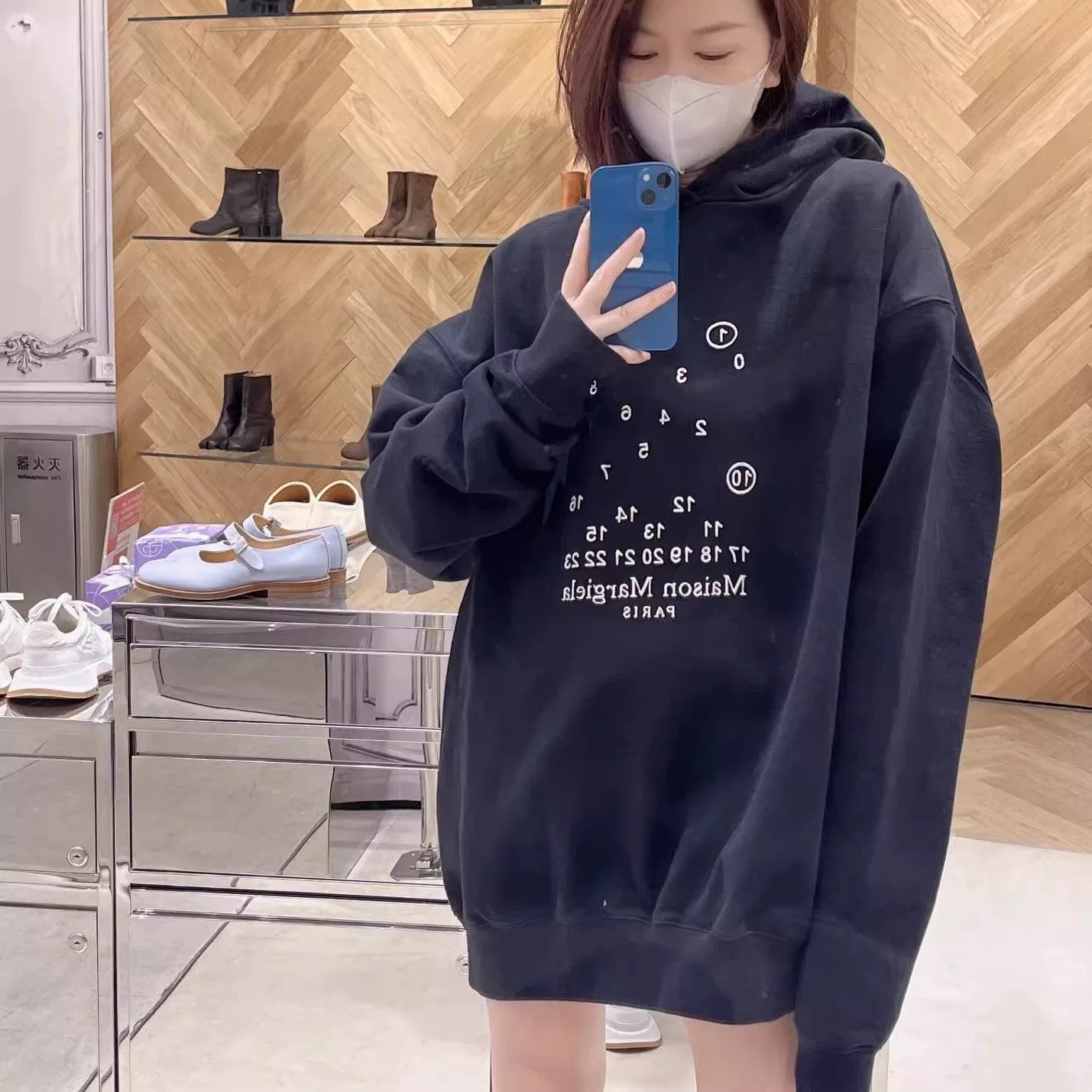 Maison Margiela hooded sweatshirt in dark navy with number graphic, worn by model